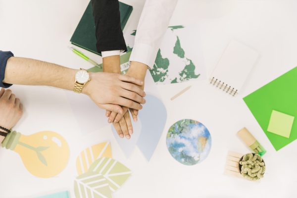 group-businesspeople-stacking-their-hands-desk